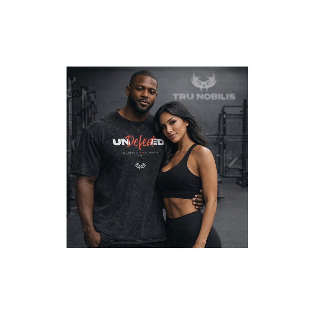 Man and woman posing together in a gym setting with 'Tru Nobilis' branding.